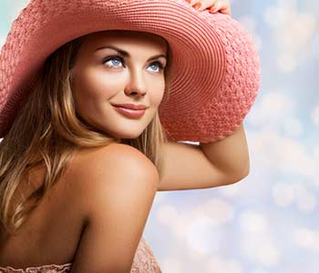 Beautiful young woman wearing a fancy pink hat